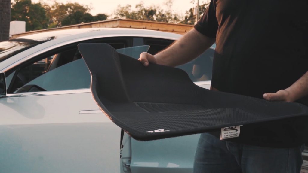Daren Goldin showing off the Maxpyder floormat for the Tesla Model 3