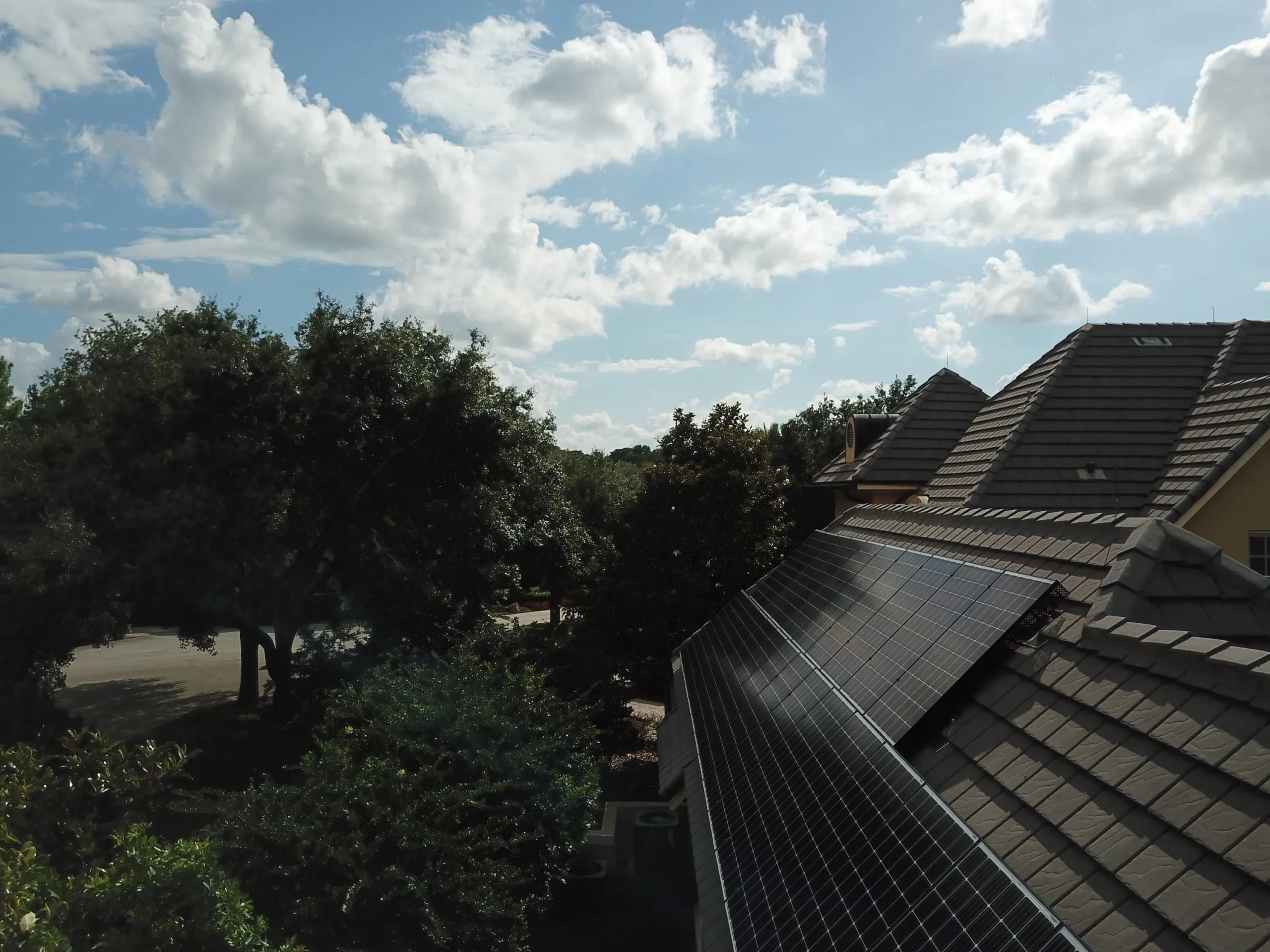 Solar panels installed on a concrete tile roof of a Florida home, seen from the side