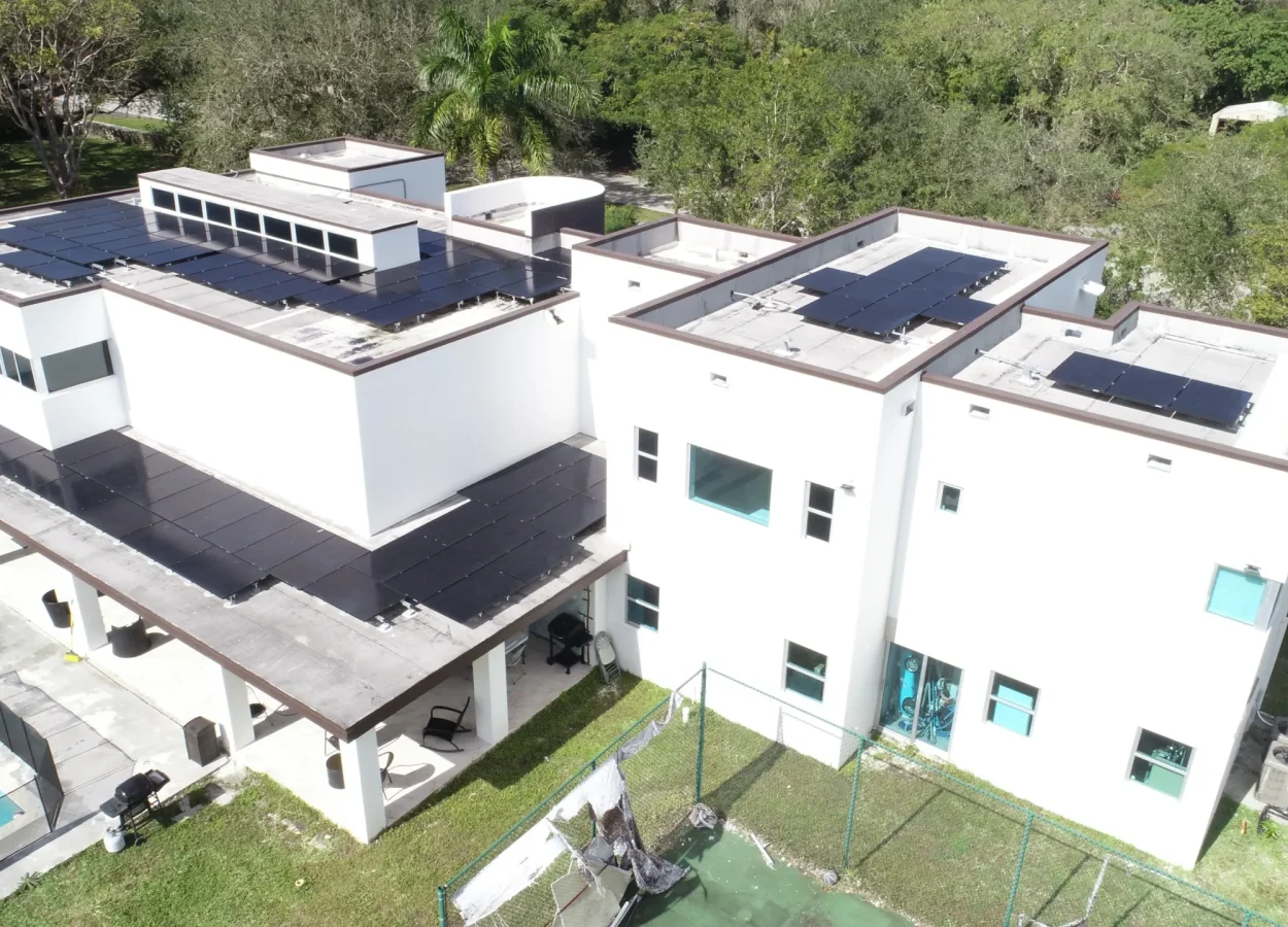 flat roof house with solar panels post hurricane. top view