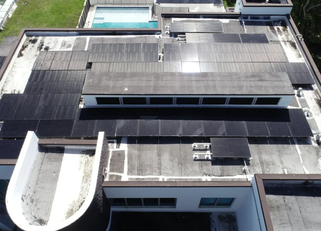 flat roof house with solar panels post hurricane. Top view