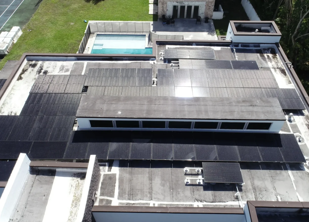 flat roof house with solar panels post hurricane. top view